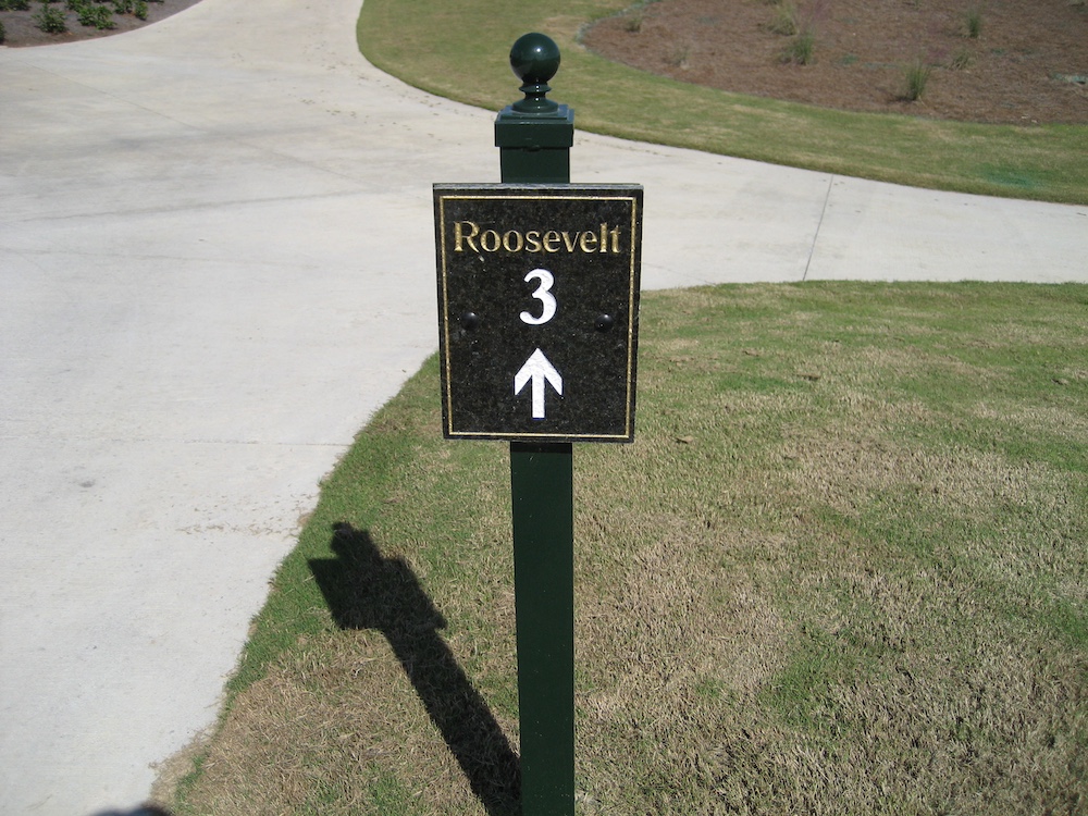 carved black granite directional sign