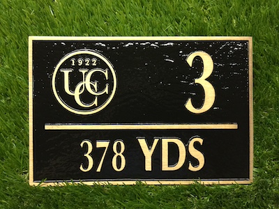 cast bronze. yardage marker painted background logo