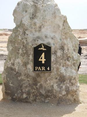 cast bronze tee sign mounted to a rock